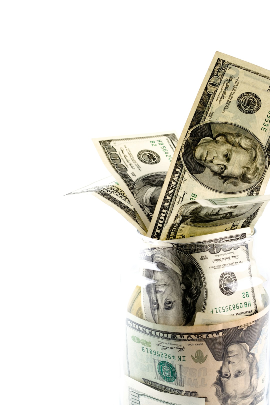 a-glass-jar-filled-with-money-sitting-on-top-of-a-table-cdgbfcsp360